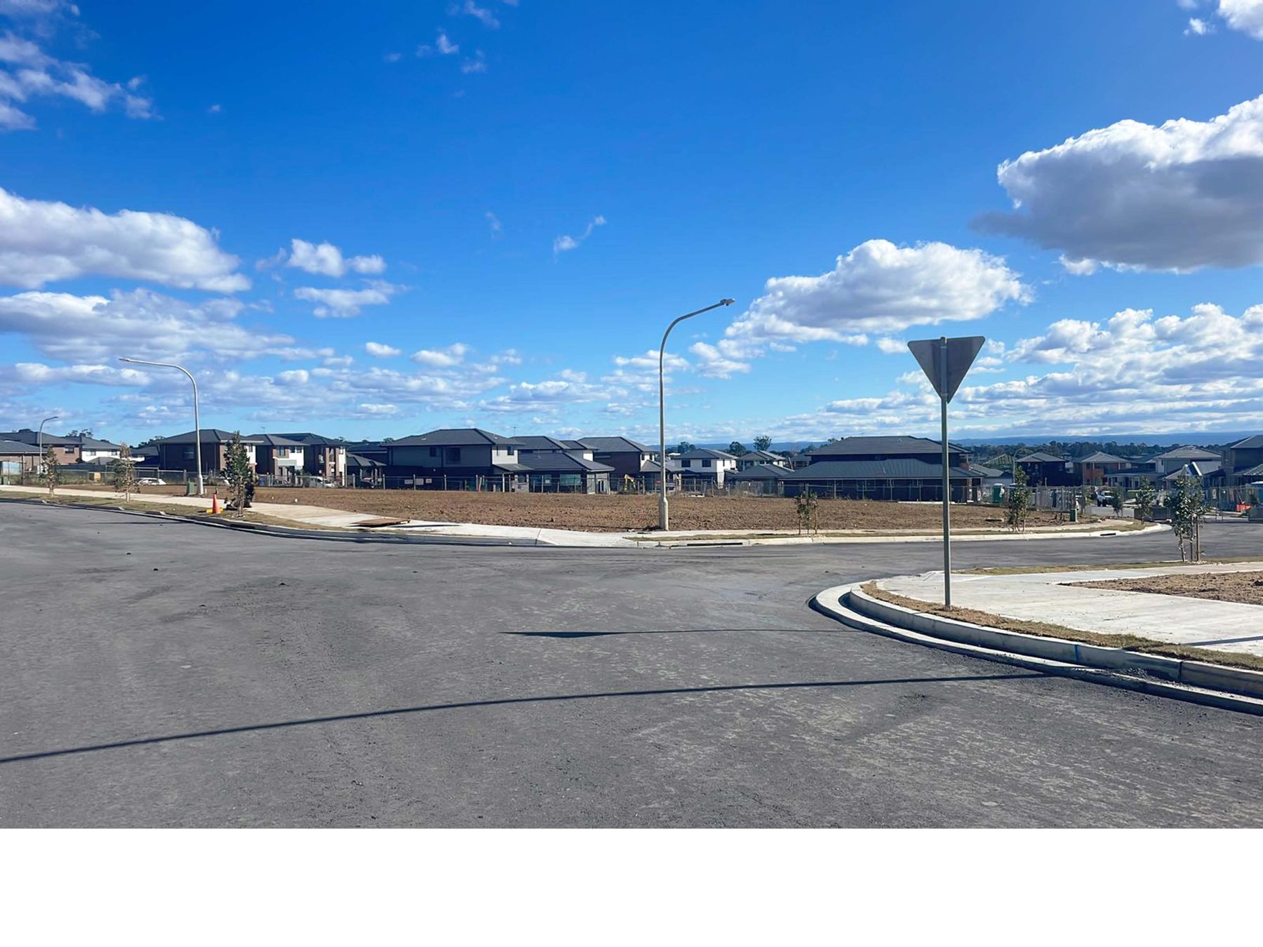 28th Avenue Austral — completed 11-lot subdivision streetscape with finished roads, kerb, footpath and signage ready for market