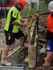 Kelso — Culnane Place: We Build Australia tradesmen working on fresh concrete formwork during civil and landscaping upgrade