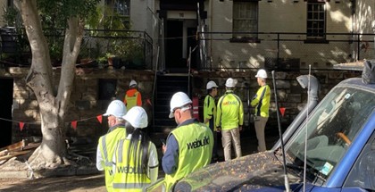 Pyrmont — We Build Australia site team in branded high-vis vests on the heritage sandstone street during construction