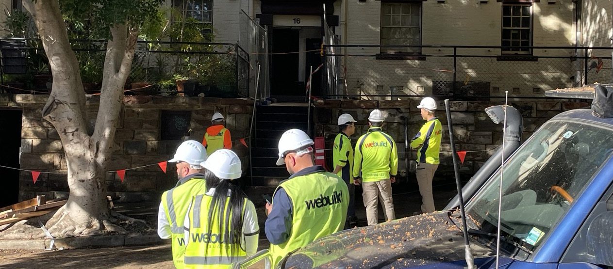 We Build Australia team in branded vests on site — representative of work across the seven sectors