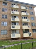South Coogee — five-storey residential apartment building with balconies and security fencing where remedial concrete spalling repairs were delivered