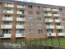 South Coogee — 19 Gregory Street brick mid-rise apartment building with balconies prior to concrete spalling repair and waterproofing rectification