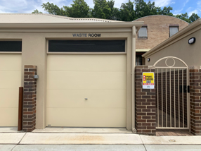 Walker Street, Waterloo — AFTER: completed new waste room with roller door, brick gate post and refreshed rear-lane infrastructure